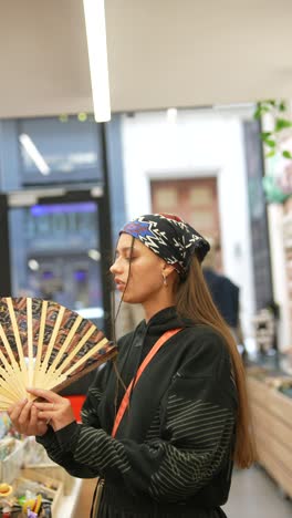 teenager with a handheld fan