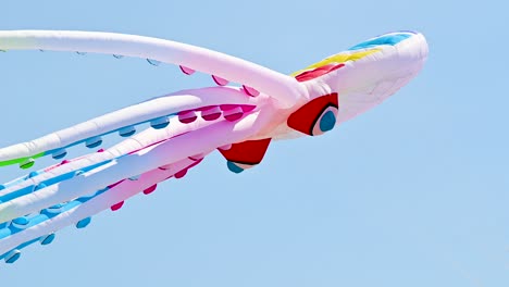 Low-angle-footage-of-a-massive-octopus-kite-on-a-hot-sunny-day-in-Spain-by-the-beach