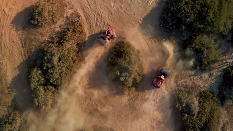 Aerial-closeup-of-two-four-wheelers-racing-in-circles-on-a-dirt-path-in-cavo-Greko