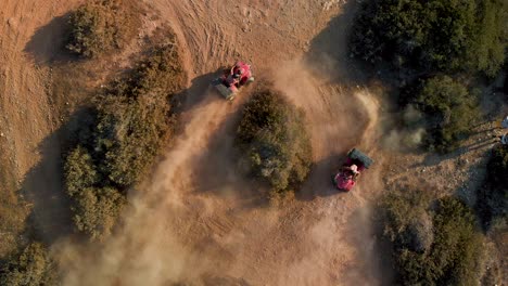 aerial closeup of two four wheelers racing in circles on a dirt path in cavo greko