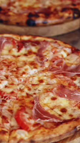 Chef making pizza. Baker hands placing ingredients on pizza