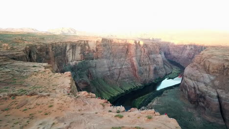 aerial shot of tourists at horseshoe bend overlook lookout, tourist destination in usa