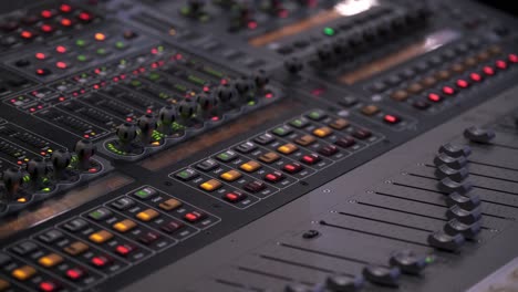 faders and lights starts to move in vegas mode on the sound board during a music festival in ontario, canada - closeup shot