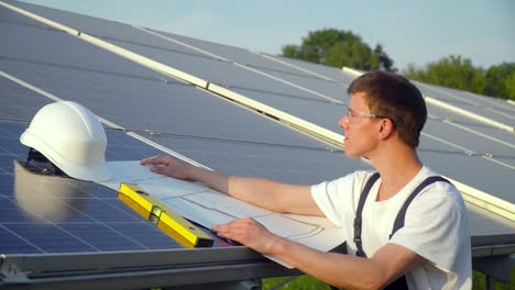 engineer in a special equipment is at the solar power station. the green energy concept