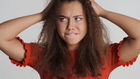 caucasian curly haired woman fooling around in front of the camera.