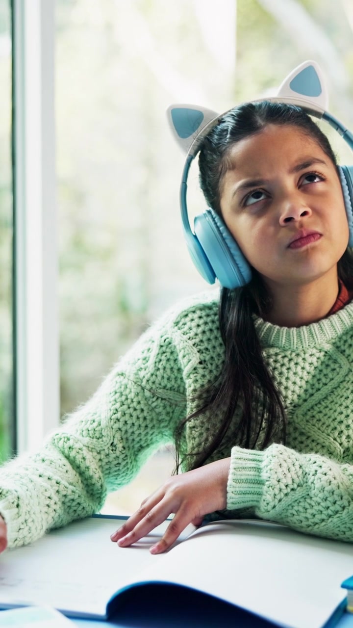 Young Girl Wearing Cat-Ear Headphones Studying at Home