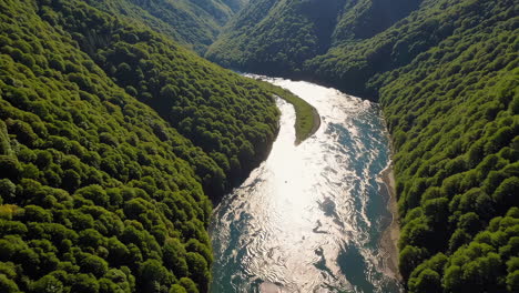 aerial view of a river winding through a lush green mountain valley