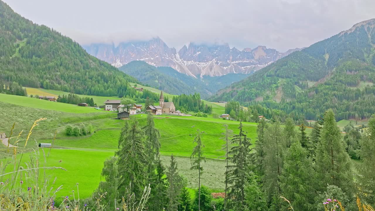 Santa Maddalena church, South Tyrol Alpine valley with mountain backdrop