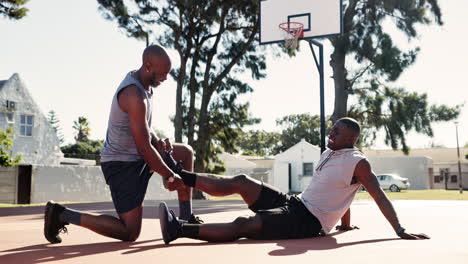 athlete helping injured teammate on basketball court