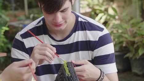 young man painting a tire craft