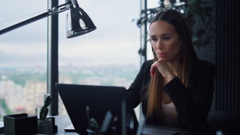 serious woman typing on keyboard