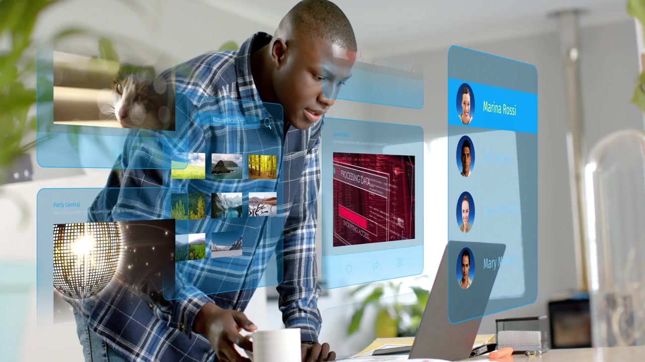 Man typing and tapping laptop causing tech UI updating contacts cycling media reaching mug for work