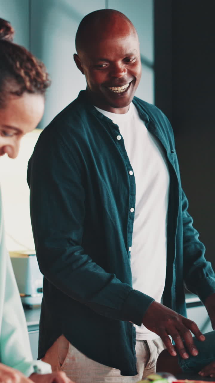 African American Man Talking and Laughing with Woman in Kitchen
