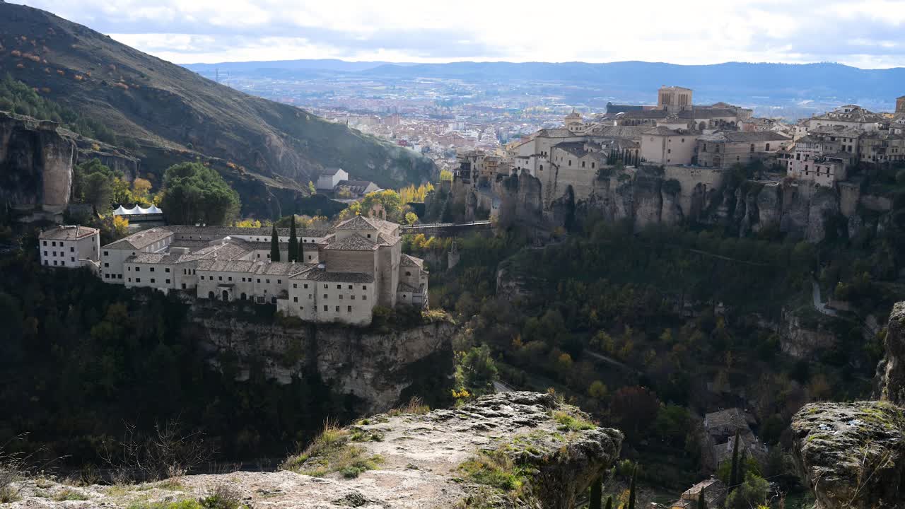This classic panoramic view of Cuenca, Spain, captures the Parador hotel, the San Pablo bridge, and the Hanging Houses within the dramatic Huecar gorge.