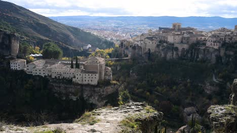 this classic panoramic view of cuenca, spain, captures the parador hotel, the san pablo bridge, and the hanging houses within the dramatic huecar gorge.