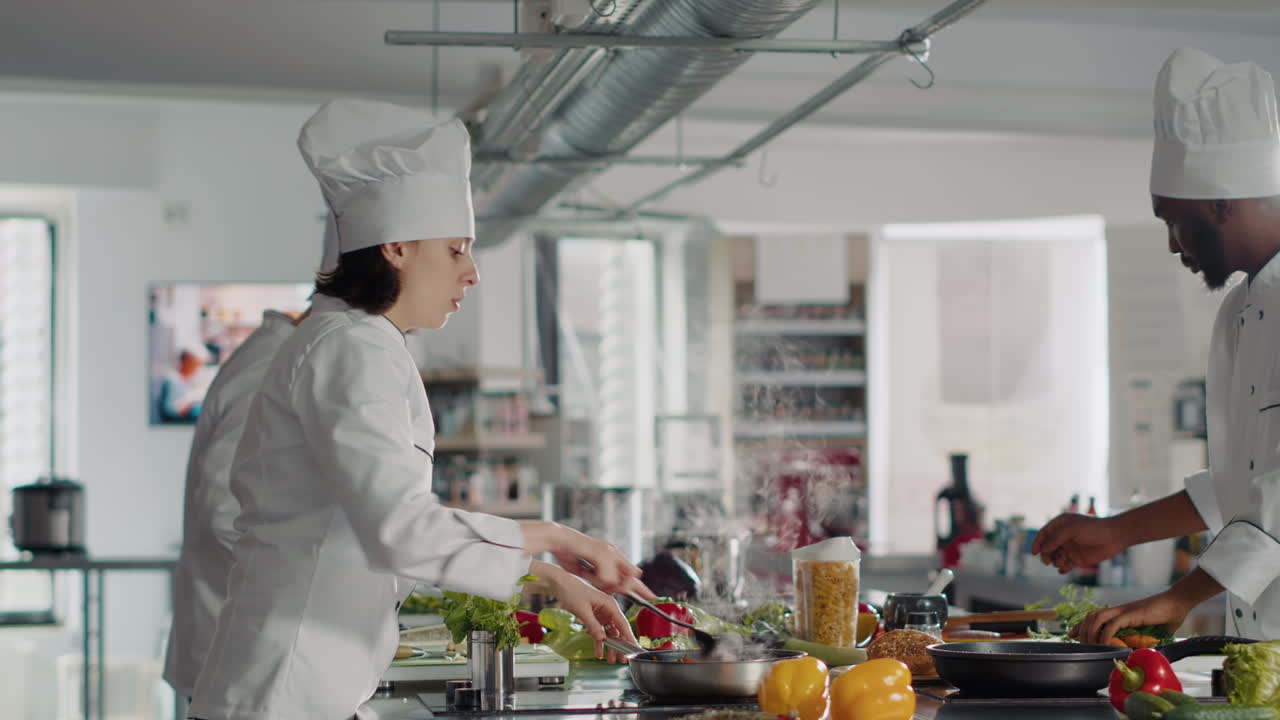 Female cook smelling rosemary leaves to use on food dish