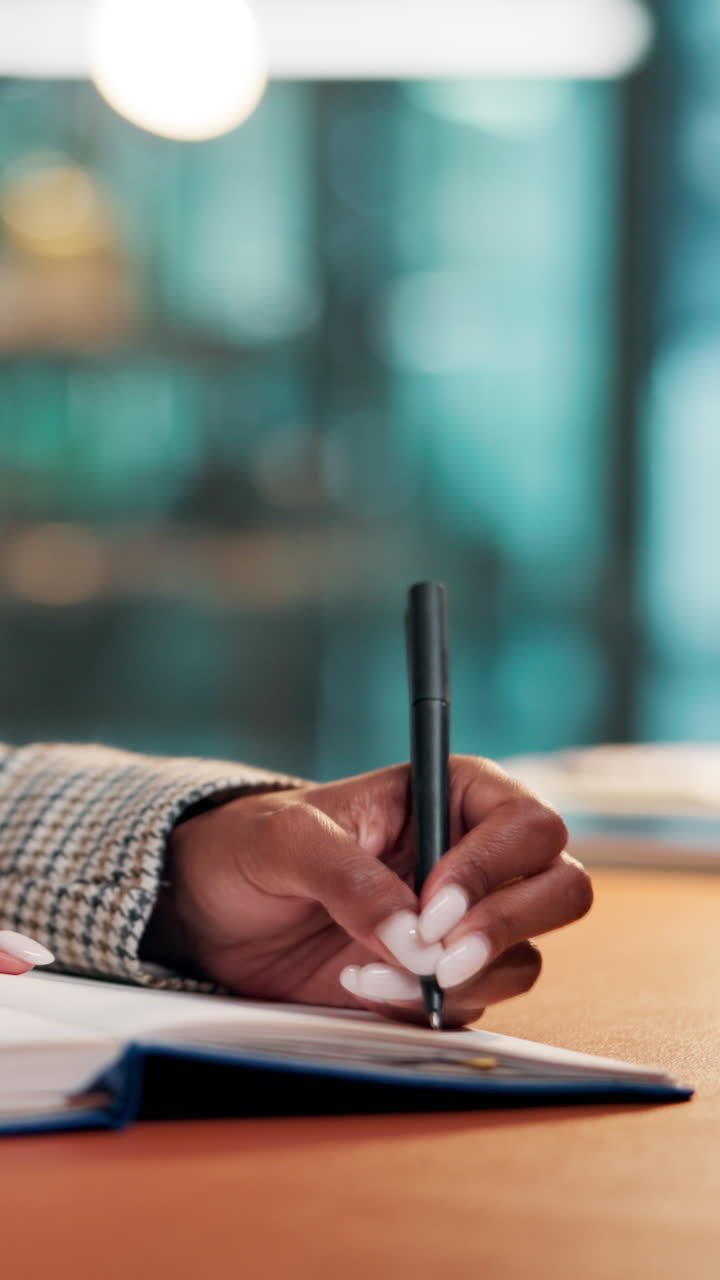 Close Up of Woman's Hand Writing Notes in a Planner