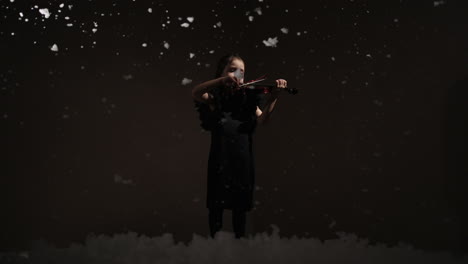 young girl playing violin in a winter scene