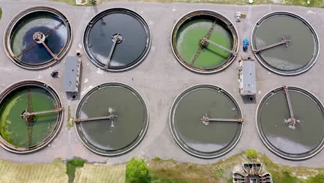 aerial shot of a wastewater treatment plant and distant skyline. big city waste processing concept