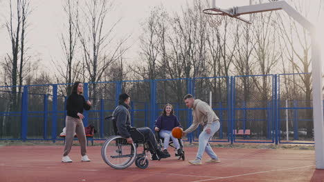 group of friends playing to basketball in the court 1