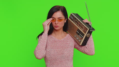 woman using retro tape record player to listen music, disco dancing of favorite track, having fun