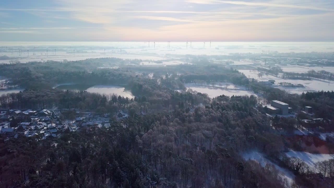 Aerial View Of Snowy Village With Dense Forest At Wintertime