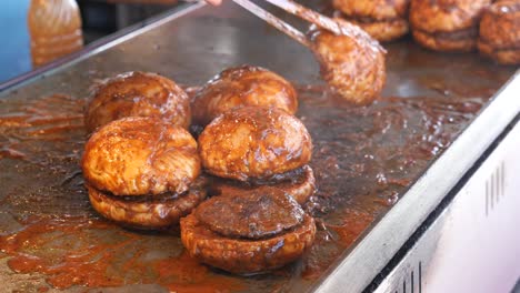 cooking up some delicious burgers on a hot griddle