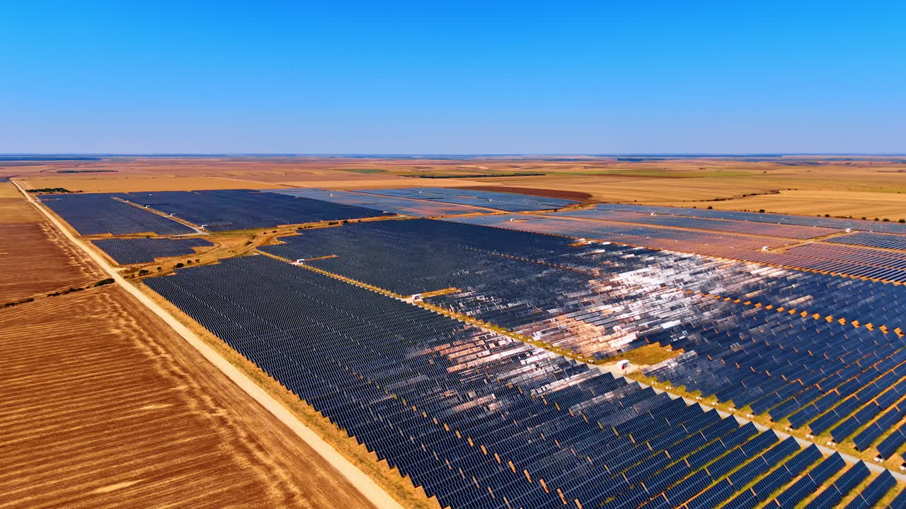 Photovoltaic solar farm with reflective panels. Aerial photo of a modern photovoltaic solar farm with reflective blue panels generating sustainable energy