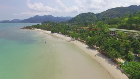 ascending aerial shot tourist beach in tropical koh chang with jungle sea view