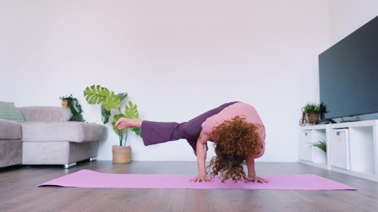 Woman Practicing Advanced Yoga Arm Balance Pose at Home