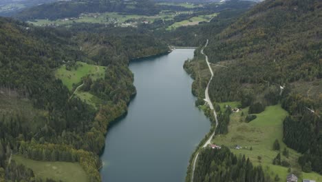 full view of freibach reservoir in austria looking at north shore, aerial tilt up reveal shot