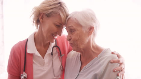 female doctor consoling to a senior woman