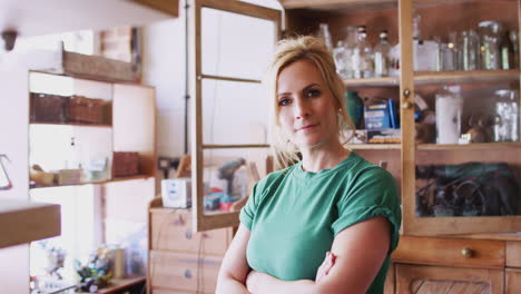 portrait of confident woman working in workshop on upcycling and craft projects