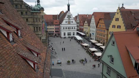 4k aerial drone video of the historic clock tower and town hall on the market square of the walled city of rothenburg ob der tauber, germany