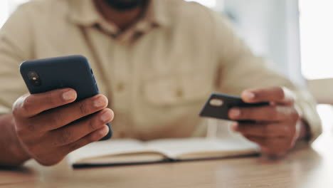 hands, credit card and phone for banking