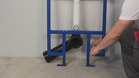 the worker who repairs and installs the toilet bowl and flush uses tools such as pliers and spanners
