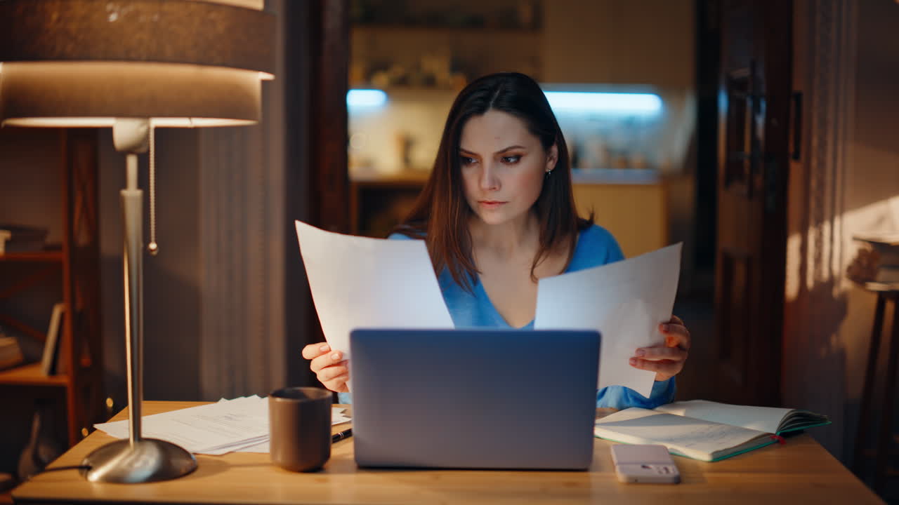 Woman manage financial documents frustrated bank loan at evening home closeup