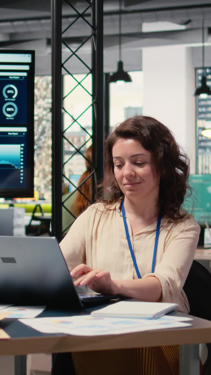 Vertical Video Businesswoman evaluates key performance metrics and writes reports