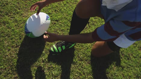 young adult female rugby player on a rugby pitch