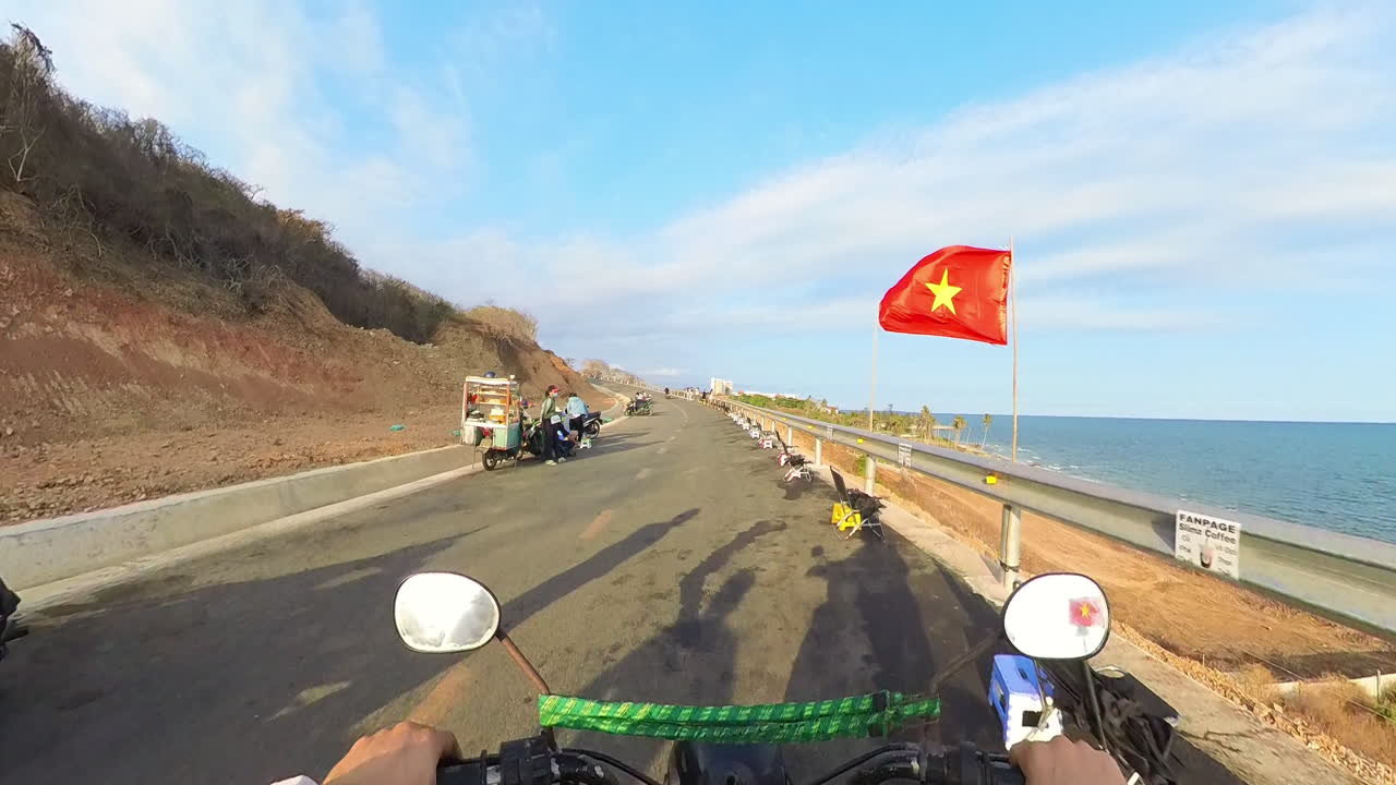 Backpacker Traveling On The Coastal Road Of Mui Ne To Phan Thiet, In Binh Thuan, Vietnam. Motorbike POV. Action Shot.