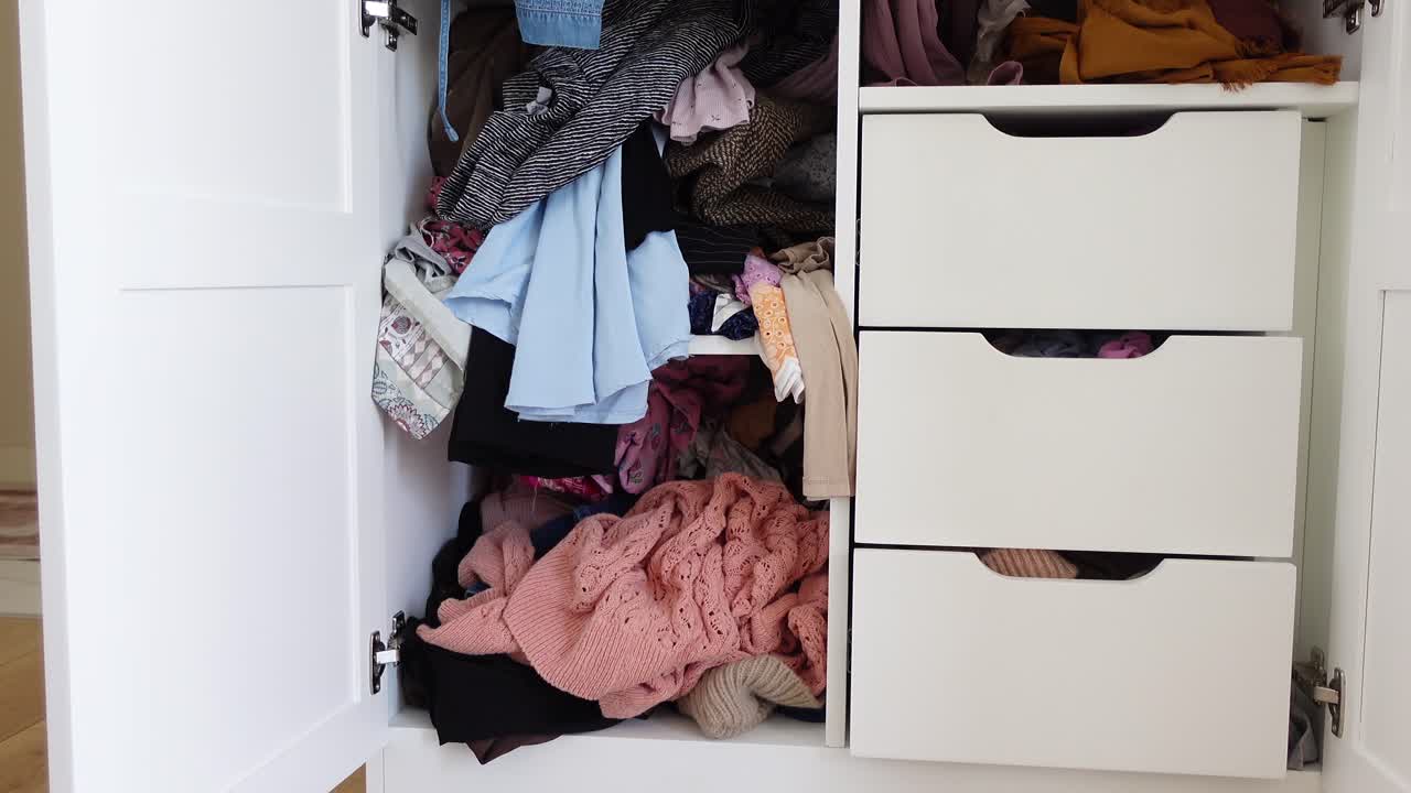 Messy Wardrobe with Clothes and Drawers