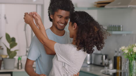 happy young couple dancing at home enjoying funny dance having fun celebrating