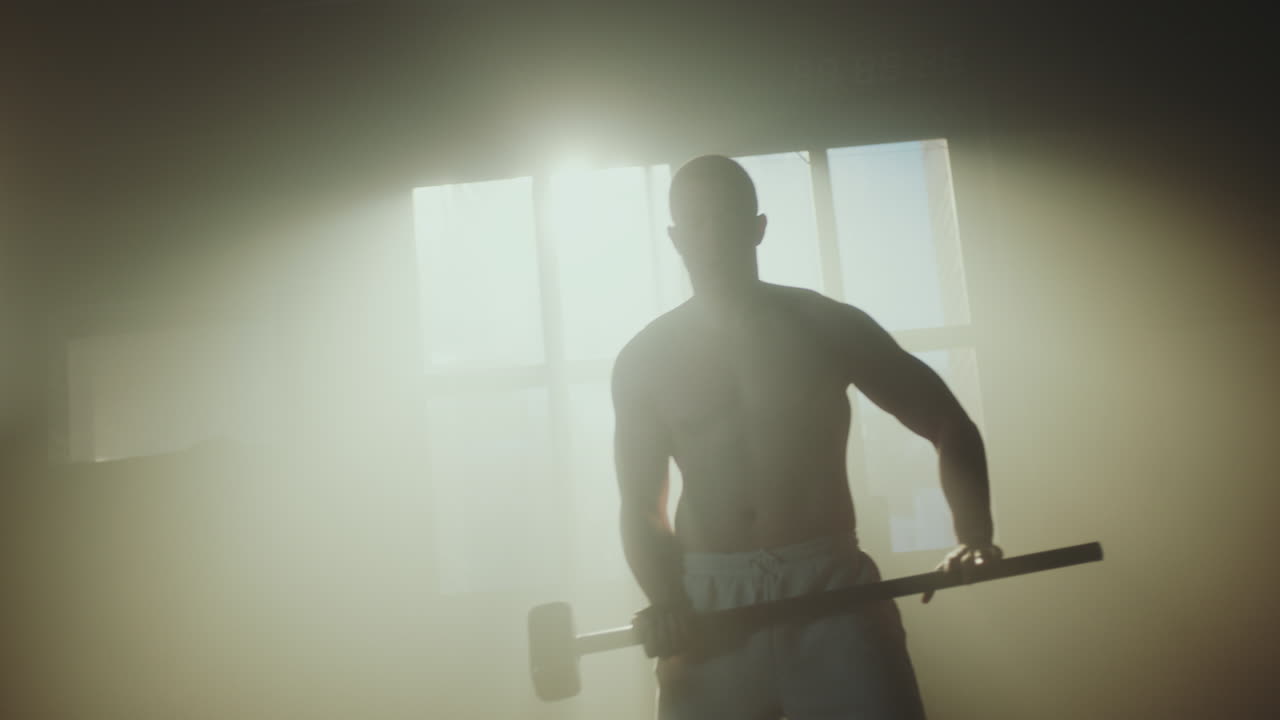 Man performing tire flips and hammer workouts