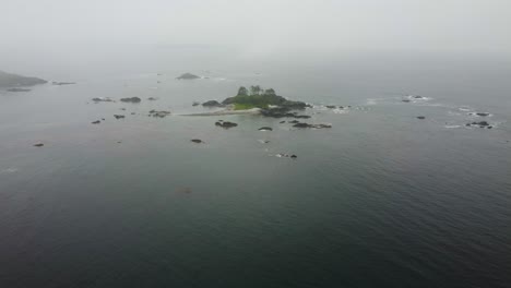 cinematic foggy drone fly over shot approaching an island in nootka sound off the west coast of vancouver island british columbia bc canada