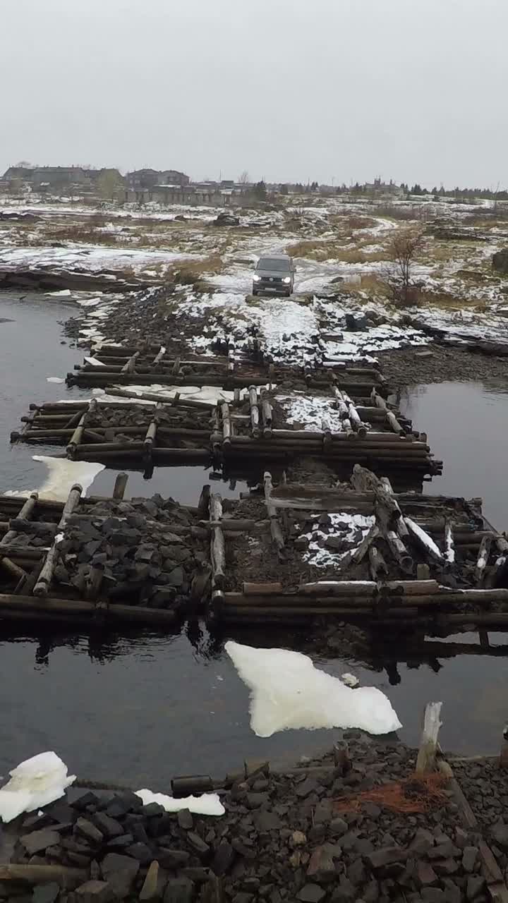 Rocky and Wooden Bridge Over Water in Winter