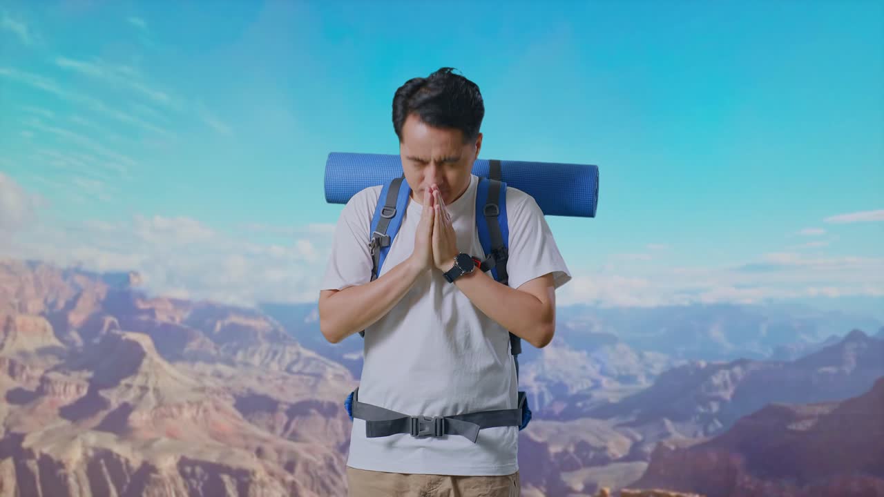 Asian Male Hiker With Mountaineering Backpack Pray For Something While Traveling At The Top Of Mountain