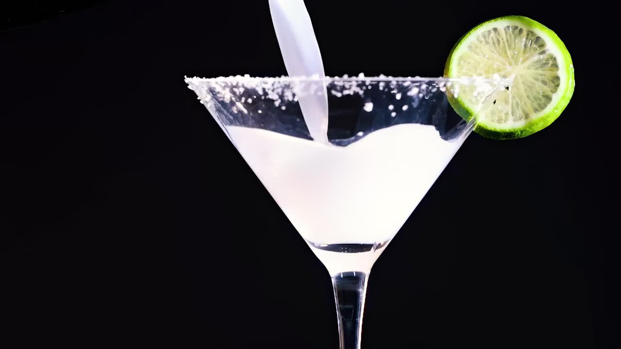 A series of images showing a cocktail being poured into a lime-garnished glass.