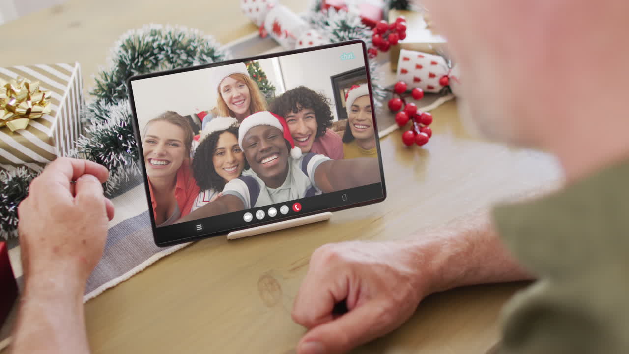 animación de un hombre caucásico mayor en una llamada de video de tableta con amigos en navidad