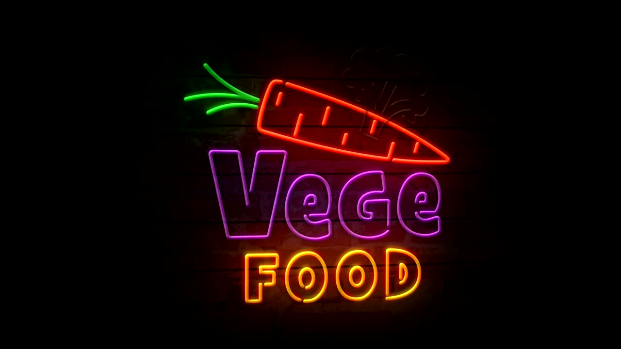 comida vegetal de neón en la pared de ladrillo