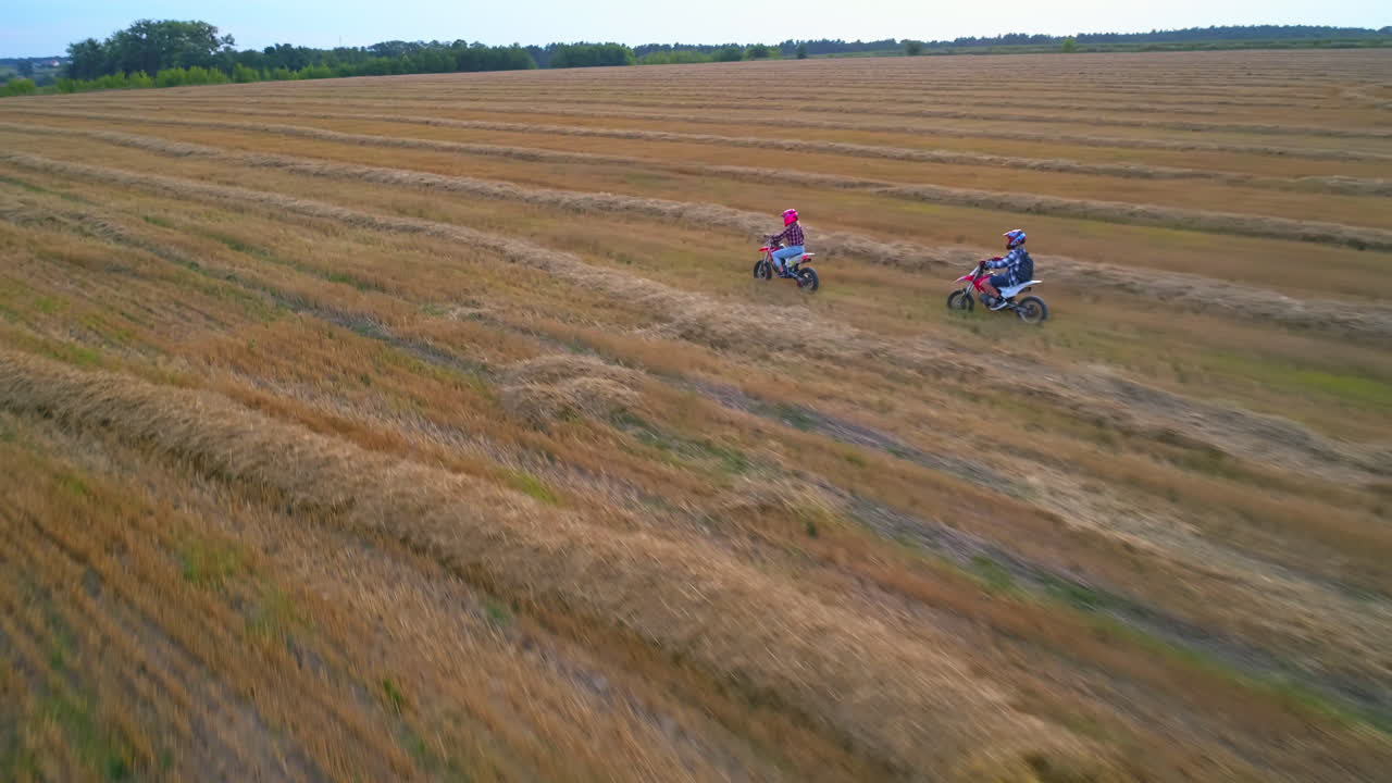 Children riding motorbikes in a field